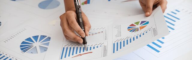 Data analytics with graphs and pen. 